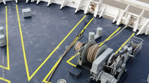 Mooring rope being winched back on deck using an electric winch before departure photo