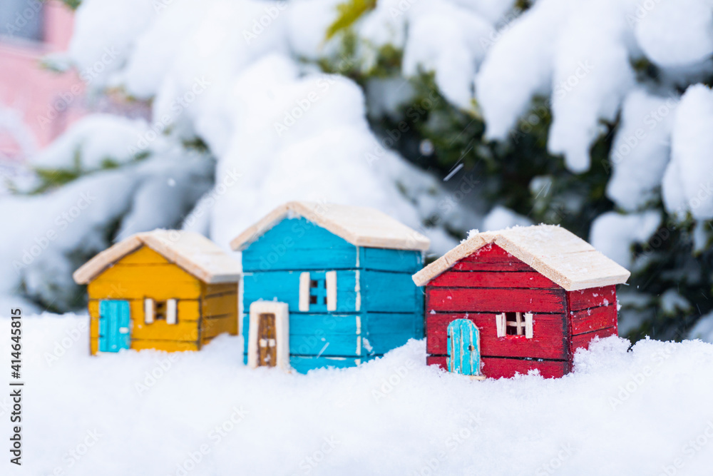 Naklejka premium colored wooden model house in snow