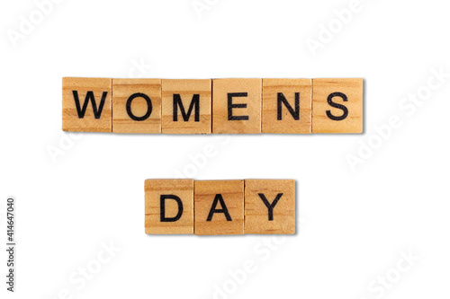 Top view of the word womens day laid out from square wooden tiles isolated on white background. World and international day.