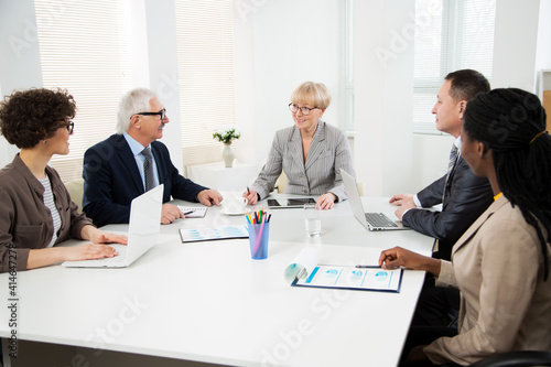 Wallpaper Mural Group of multi-ethnic business people sitting around the office desk and discussing the project Torontodigital.ca