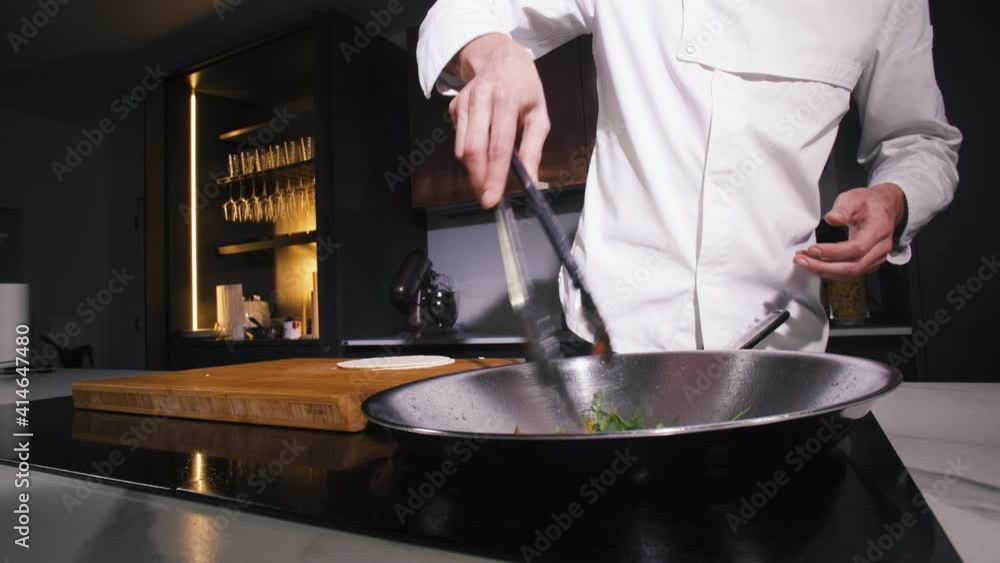 Chef Stir Fried Vegetables Into Frying Pan In Restaurant Kitchen. Cooking Vegetarian Food In Wok At Modern Kitchen. Cook Making Delicious Vegan Meal. Man Person Preparing Dish For Dinner In Cuisine. Chef Stir Fried Vegetables Into Frying Pan In Restaurant Kitchen. Cooking Vegetarian Food In Wok At Modern Kitchen. Cook Making Delicious Vegan Meal. Man Person Preparing Dish For Dinner In Cuisine.