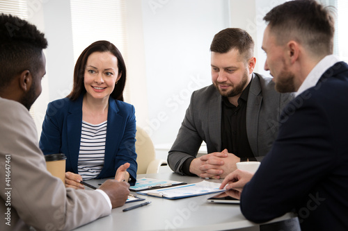 Wallpaper Mural Group of business people sitting around the office desk and discussing the project Torontodigital.ca