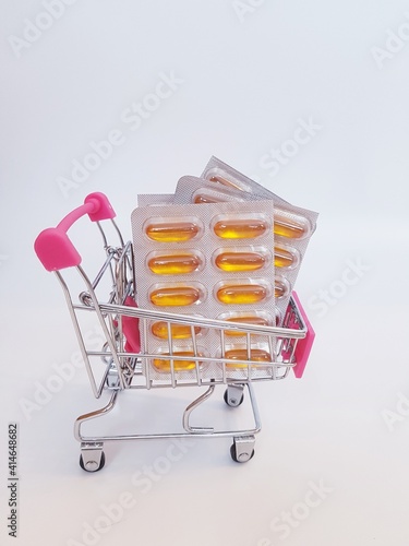 Food cart with pills on white background. Concept of medicine, treatment, use, purchase and sale of medicines.