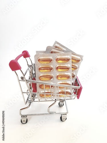 Food cart with pills on white background. Concept of medicine, treatment, use, purchase and sale of medicines.