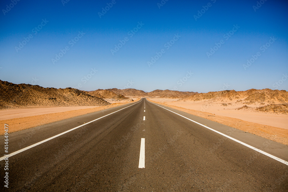 Road in the sahara desert of Egypt. Conceptual for freedom, enjoying the journey. Empty road. Freeway, Highway through the desert