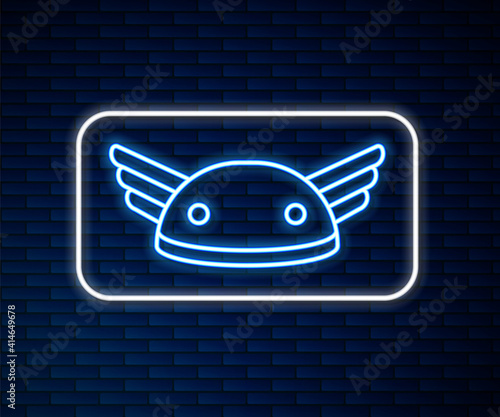 Glowing neon line Helmet with wings icon isolated on brick wall background. Greek god Hermes. Vector.