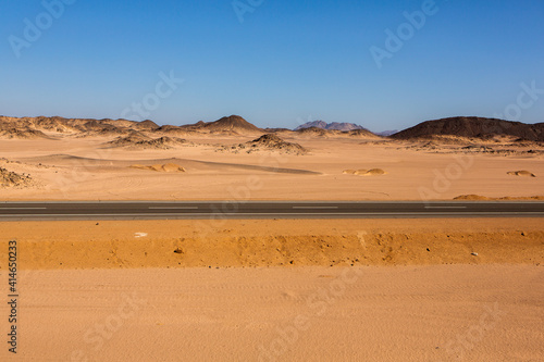 Road in the sahara desert of Egypt. Conceptual for freedom  enjoying the journey. Empty road. Freeway  Highway through the desert