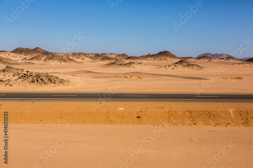 Road in the sahara desert of Egypt. Conceptual for freedom  enjoying the journey. Empty road. Freeway  Highway through the desert