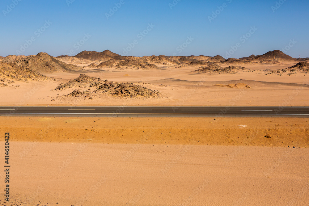 Road in the sahara desert of Egypt. Conceptual for freedom, enjoying the journey. Empty road. Freeway, Highway through the desert Road in the sahara desert of Egypt. Conceptual for freedom, enjoying the journey. Empty road. Freeway, Highway through the desert