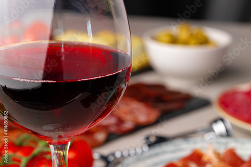 Meat slicing and wine on gray background