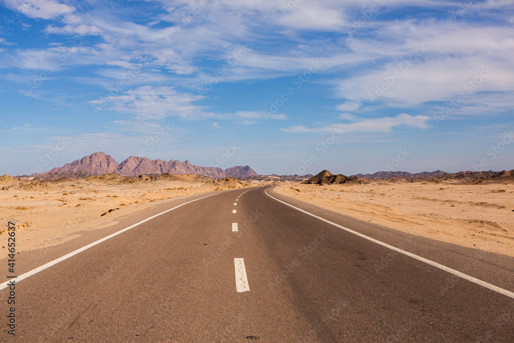 Naklejka premium Road in the sahara desert of Egypt. Conceptual for freedom, enjoying the journey. Empty road. Freeway, Highway through the desert