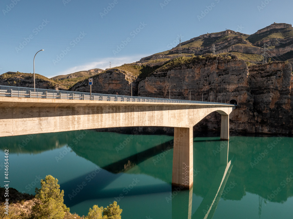 Modern concrete bridge over a reservoir filled with water. Comunidad Valenciana, Spain