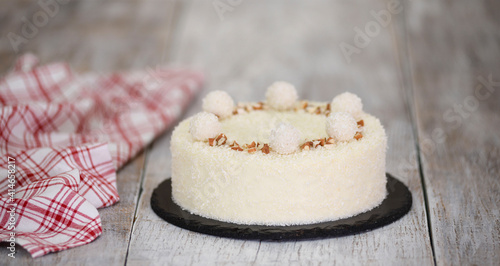 Delicious coconut mousse cake, decorated with candy and almond.