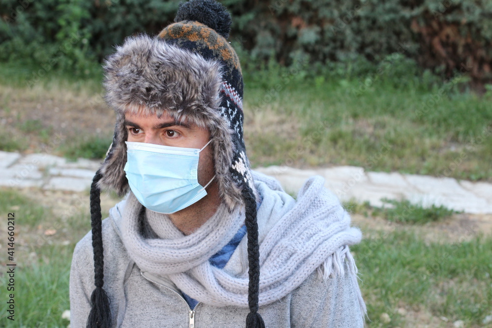 Man wearing protective surgical mask in the winter Man wearing protective surgical mask in the winter