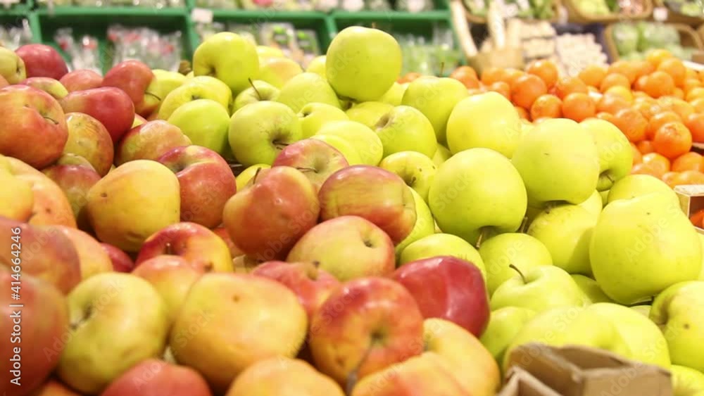Apples are sold in the store. Red and green apples on the counter with fruits. Apples are sold in the store. Red and green apples on the counter with fruits.