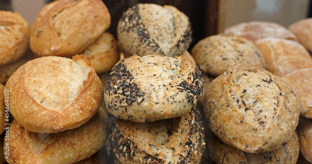 Buying bread at the store. A customer takes fresh bread with tongs at the bakery. Buying bread at the store. A customer takes fresh bread with tongs at the bakery.