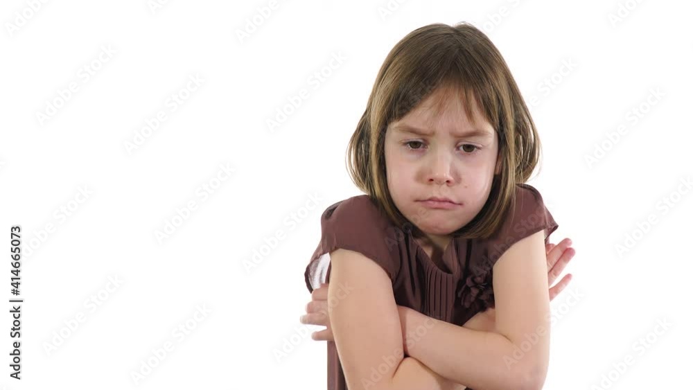 Sad, serious child. The little girl was upset with something, crossed her arms over her chest and was offended. Sad, serious child. The little girl was upset with something, crossed her arms over her chest and was offended.