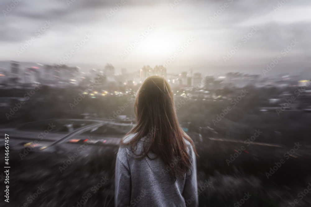 Girl looking from the mountain at the city in horror style