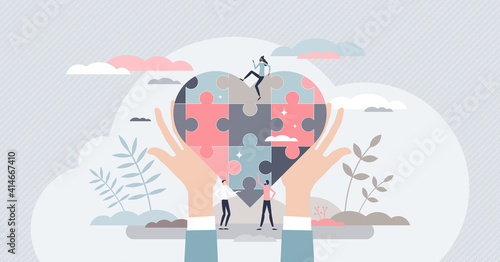 Social care with jigsaw pieces heart as charity and help tiny person concept