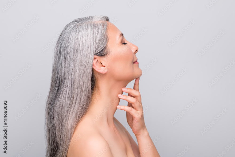 Profile portrait of optimistic nice long hair woman touch chin without clothes isolated on light grey color background - obrazy, fototapety, plakaty 