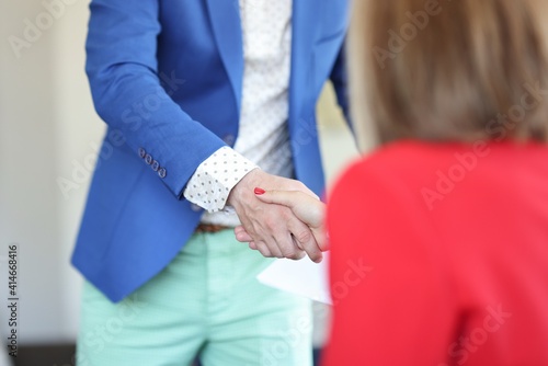 Handshake of businessman and businesswoman. Business communication and negotiation concept © H_Ko