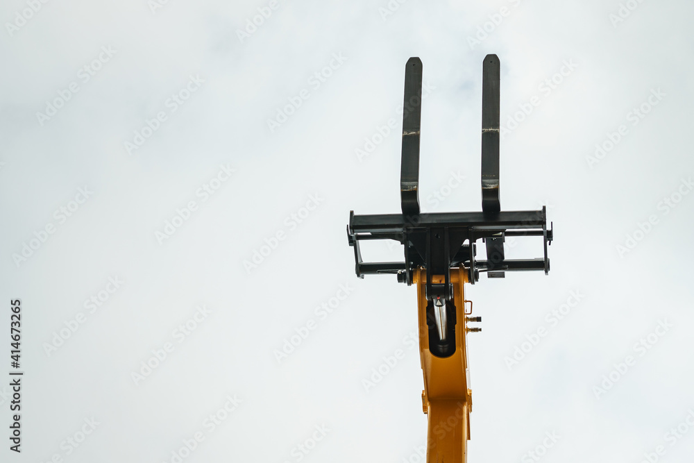 Forklift industrial loader or stacker against sky. Forklift industrial loader or stacker against sky.