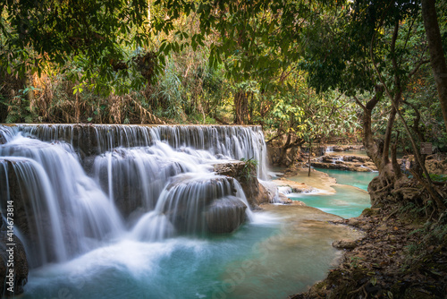 Kwang Si waterfall long exposure turquoise water forest background