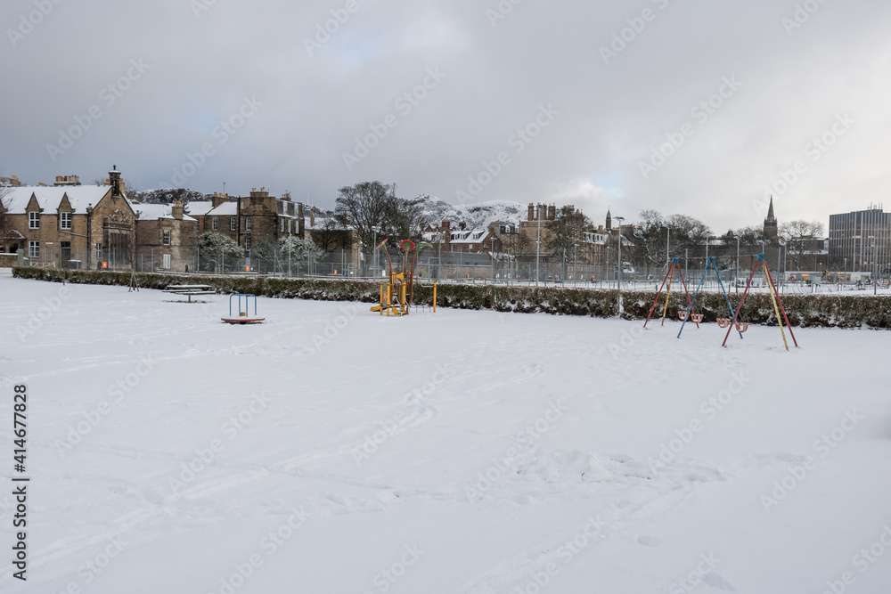 The frozen playground and tennis court at meadows during the winter covered by snow in Edinburgh, Scotland