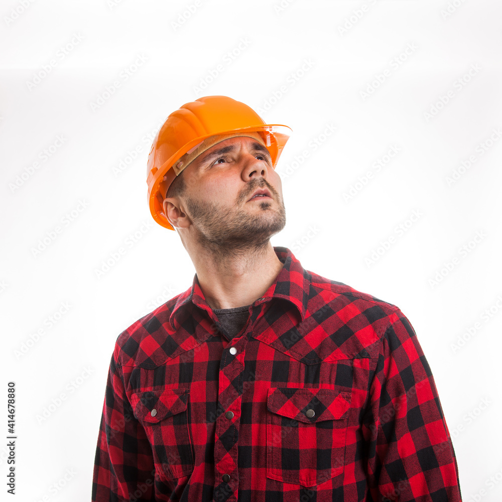 A man in a plaid shirt and a construction helmet on a white background. Concept Labor Day. A man in a plaid shirt and a construction helmet on a white background. Concept Labor Day.