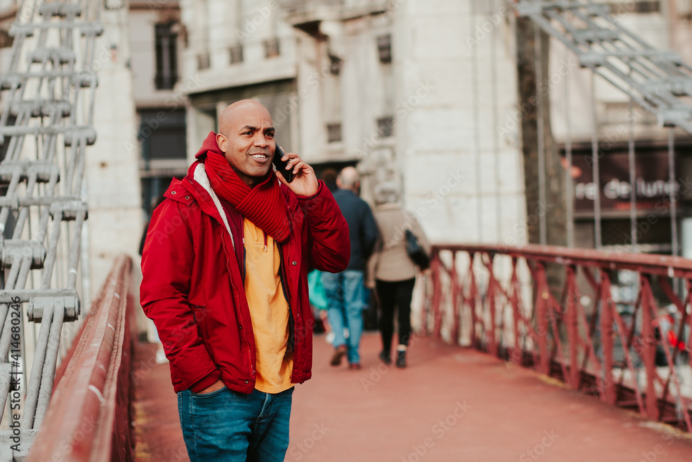 young latin man with smartphone in the city of lyon young latin man with smartphone in the city of lyon