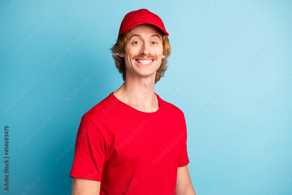 Photo of half turned satisfied person toothy smile look camera isolated on pastel blue color background Photo of half turned satisfied person toothy smile look camera isolated on pastel blue color background