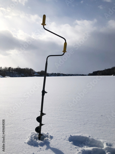 Winter ice fishing perch and hole in ice. Winter perch fishing leisure - usual pattern retrieving fish from holes
