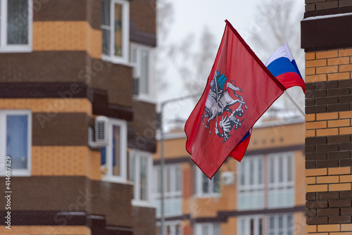 Flag of Moscow and Russia on the house. Before the holiday, they hang flags.