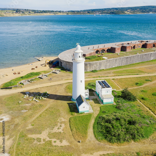 Square - aerial view of Hurst point, in the United Kingdom. Lighthouse by the sea with the castle in the background by the sea. photo