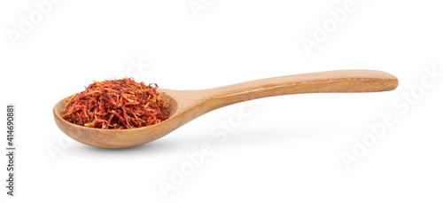 фотографія safflower in wood spoon on white background
