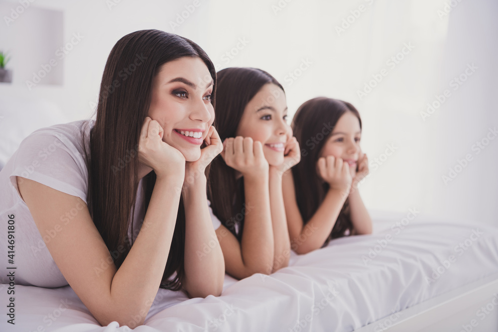 Photo of charming sweet three sisters sleepwear lying bed having rest smiling arms cheekbones inside indoors home room Photo of charming sweet three sisters sleepwear lying bed having rest smiling arms cheekbones inside indoors home room