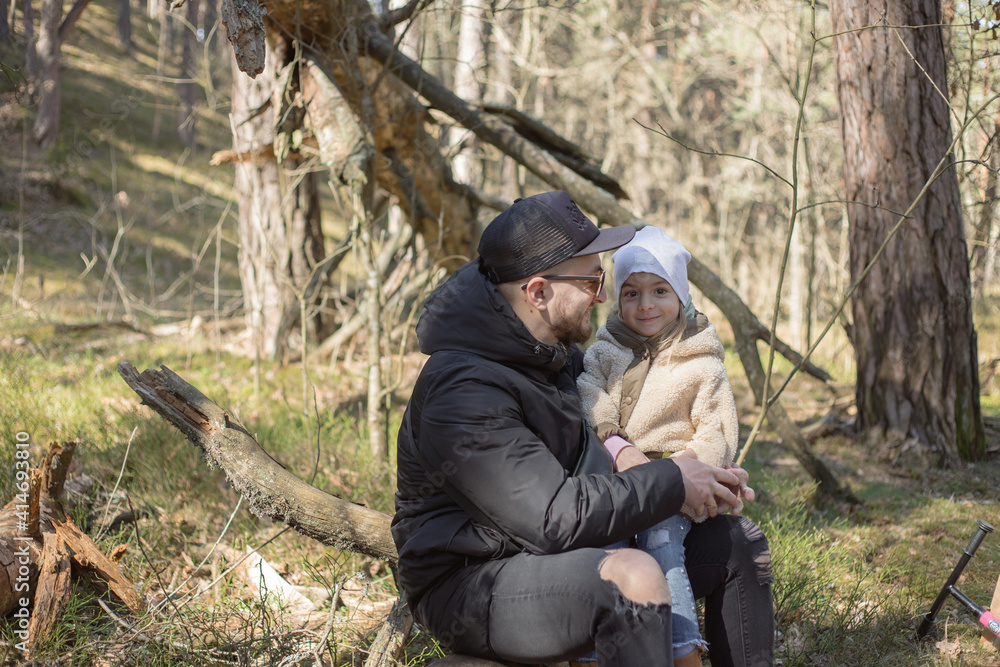 Father and little daughter spent time in he forest.Emotions, Lifestyle, Childhood concept.Family relationship. Little girl enjoying father's love outdoors. Happy family time.