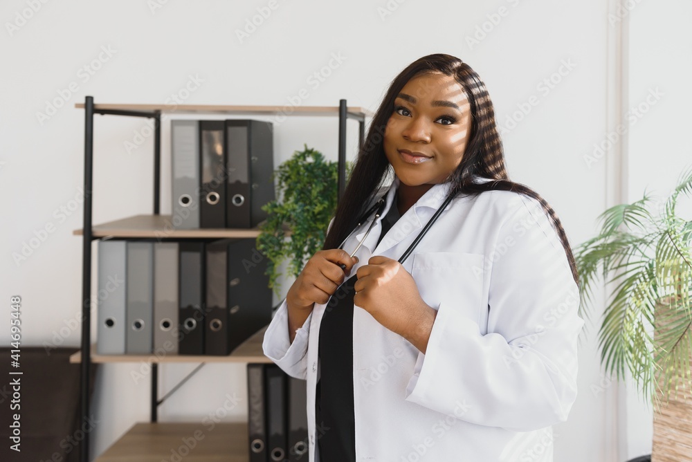 An African American female medical doctor with a stethoscope in hospital An African American female medical doctor with a stethoscope in hospital