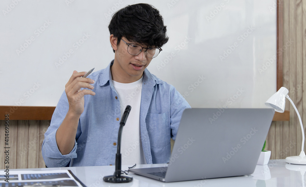 Asian university teachers are teaching mathematics with laptop to record live on internet, Long-distance study due to the virus epidemic situation, Online remote learning, Quarantine for people. Asian university teachers are teaching mathematics with laptop to record live on internet, Long-distance study due to the virus epidemic situation, Online remote learning, Quarantine for people.
