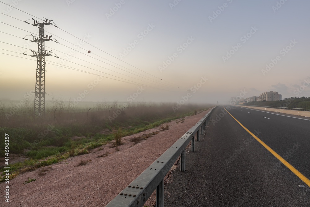 Heavy  fog over an agricultural field and intercity expressway on an early winter morning in northern Israel