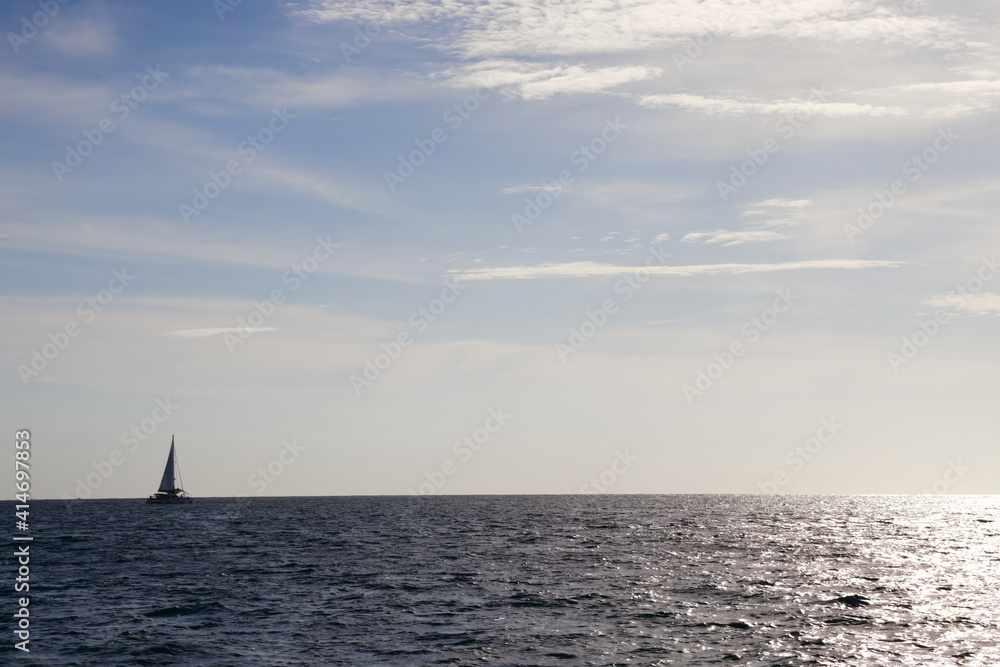 Sea cloud sunset sailboat.