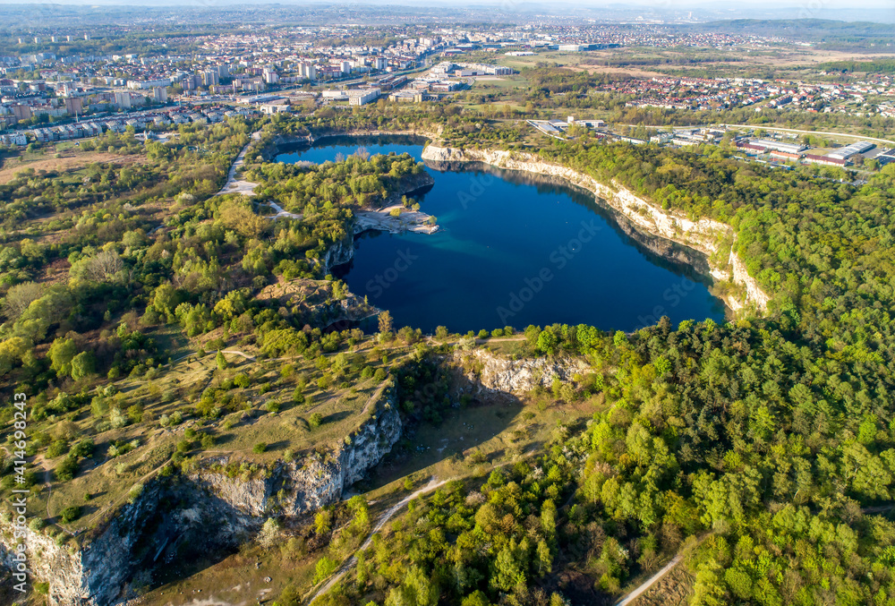 Krakow, Poland. Zakrzowek lake with steep cliffs in place of former flooded limestone quarry in Twardowski Rocks. Popular recreational place. Aerial view at sunrise