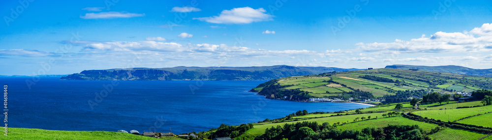 Wide panorama of Atlantic coast in County Antrim, Northern Ireland, UK, with bays, peninsulas, cliffs and villages