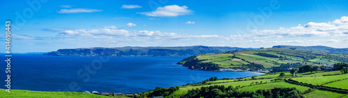 Wide panorama of Atlantic coast in County Antrim, Northern Ireland, UK, with bays, peninsulas, cliffs and villages