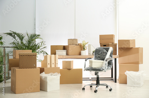 Cardboard boxes and packed chair in office. Moving day © New Africa