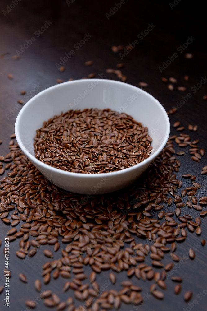 flax seeds in a white plate on the table flax seeds in a white plate on the table