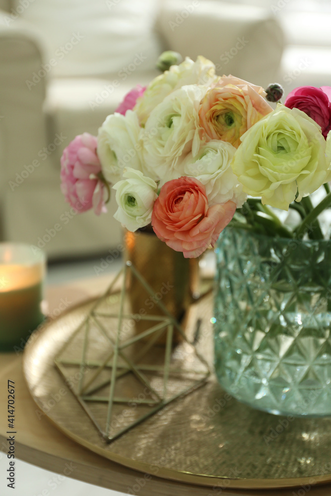 Beautiful ranunculus flowers in vase on wooden table indoors, closeup Beautiful ranunculus flowers in vase on wooden table indoors, closeup