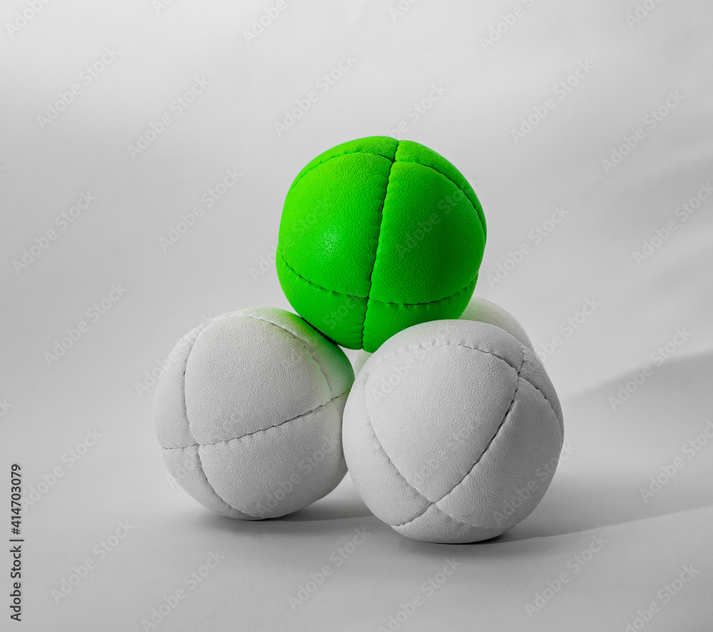 white and green juggling balls on white background