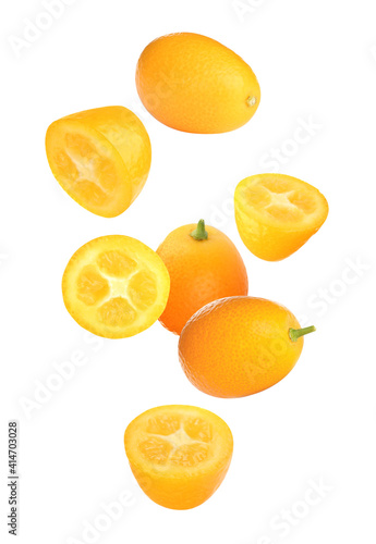 Fresh ripe kumquat fruits falling on white background