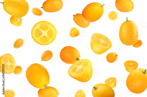 Fresh ripe kumquat fruits falling on white background